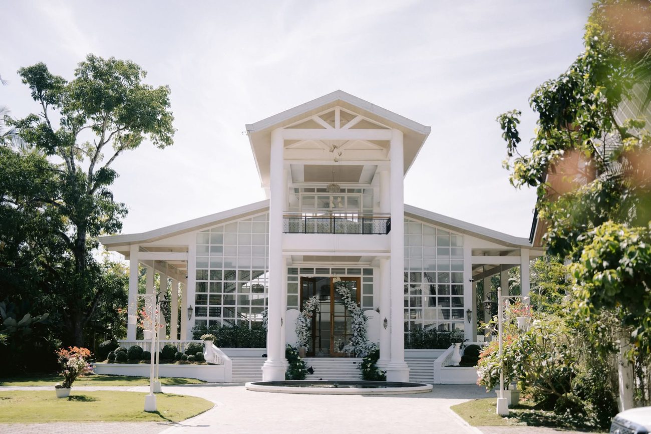 Somewhere by Casa, the glass pavilion with its white columns, seen from the driveway