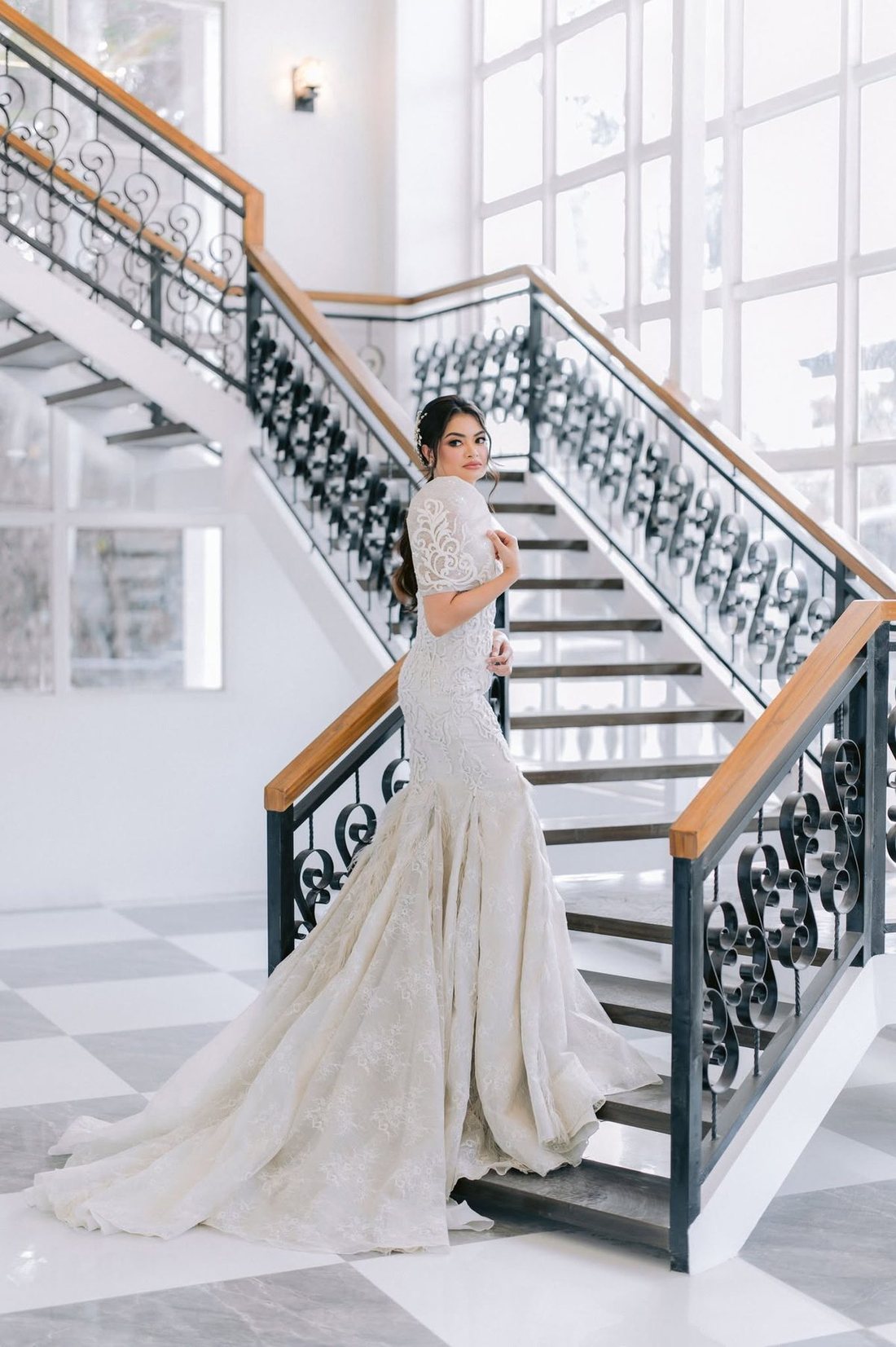 A bride on the wrought-iron staircase at Casa de Canitoan