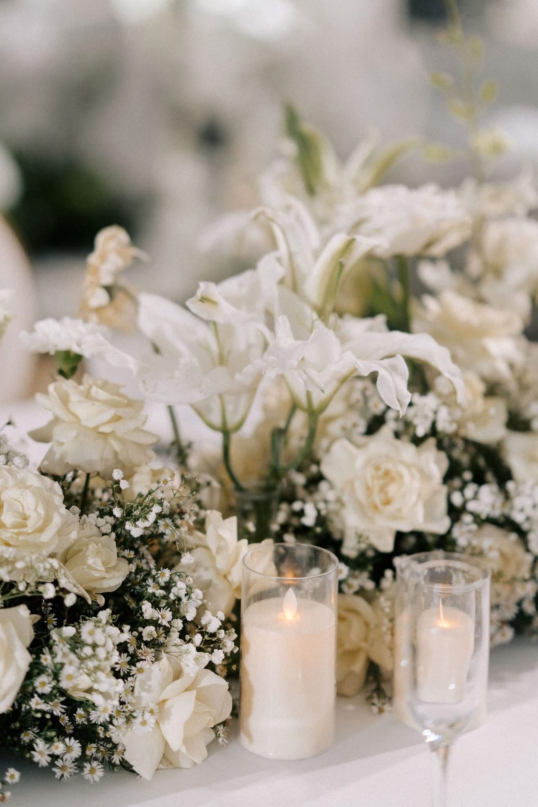White flowers and candles on a reception table